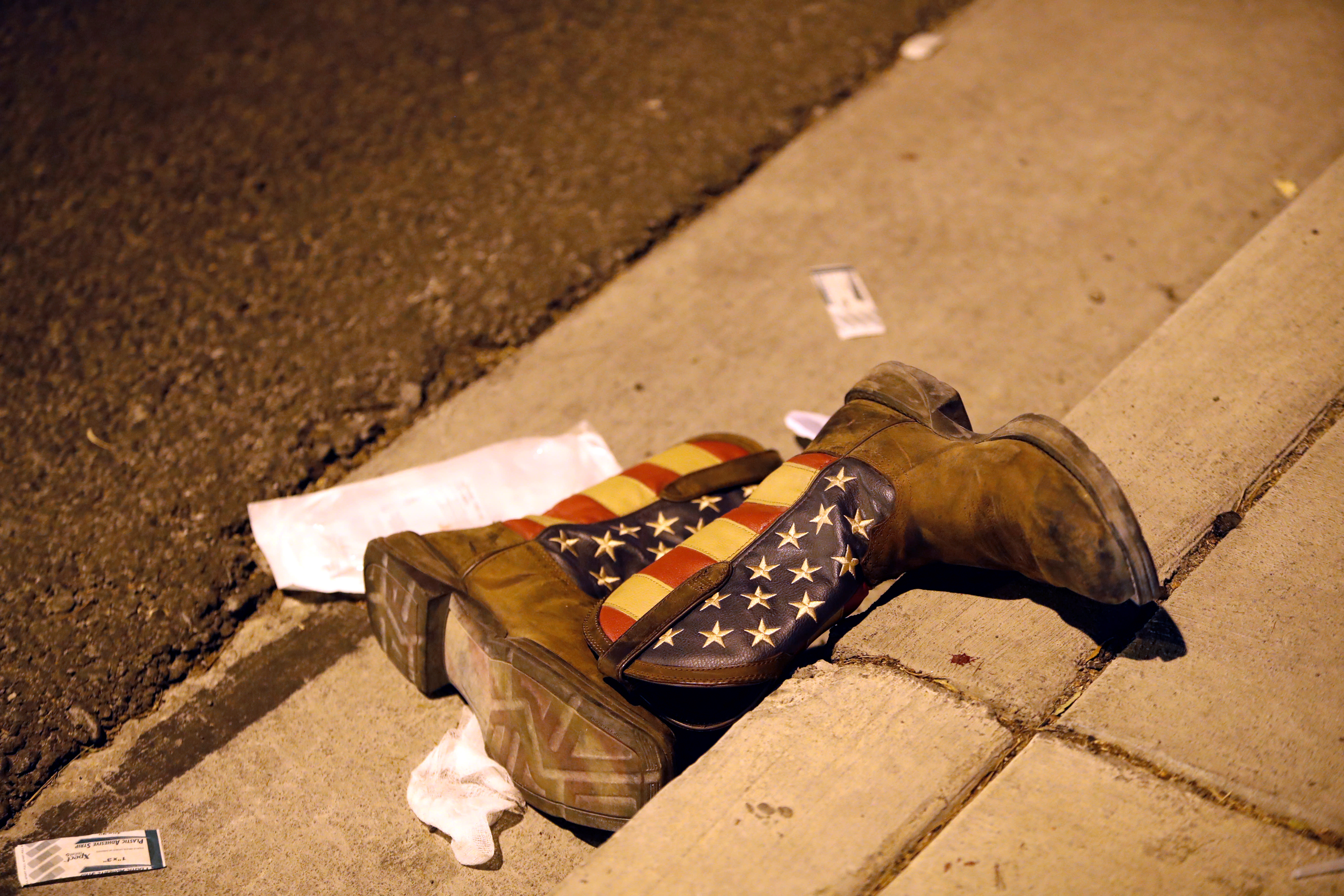 A pair of cowboy boots in the street outside the concert venue after a mass shooting in Las Vegas (STEVE MARCUS / REUTERS)