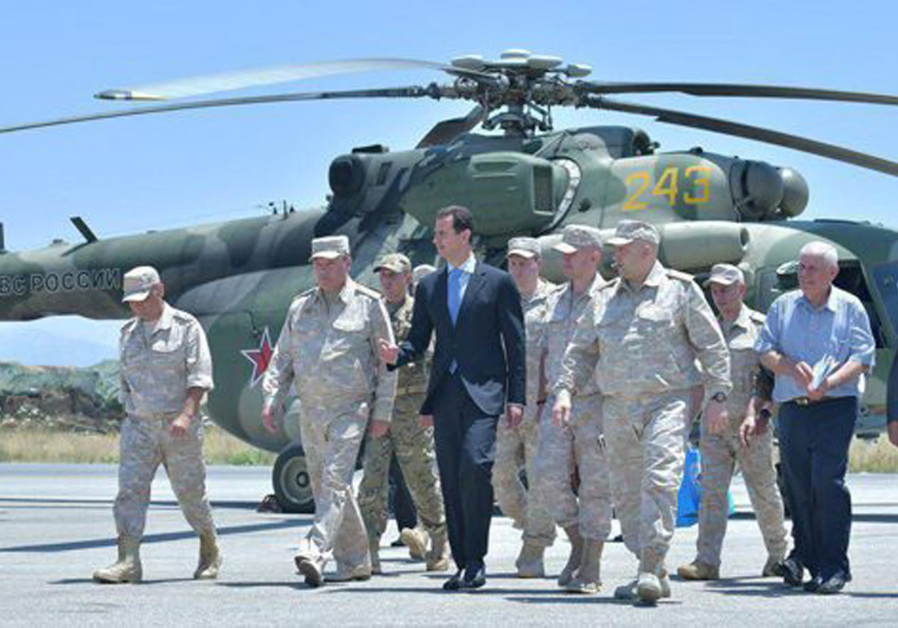 Syria's President Bashar Assad visits a Russian air base at Hmeymim, in western Syria in this handou
