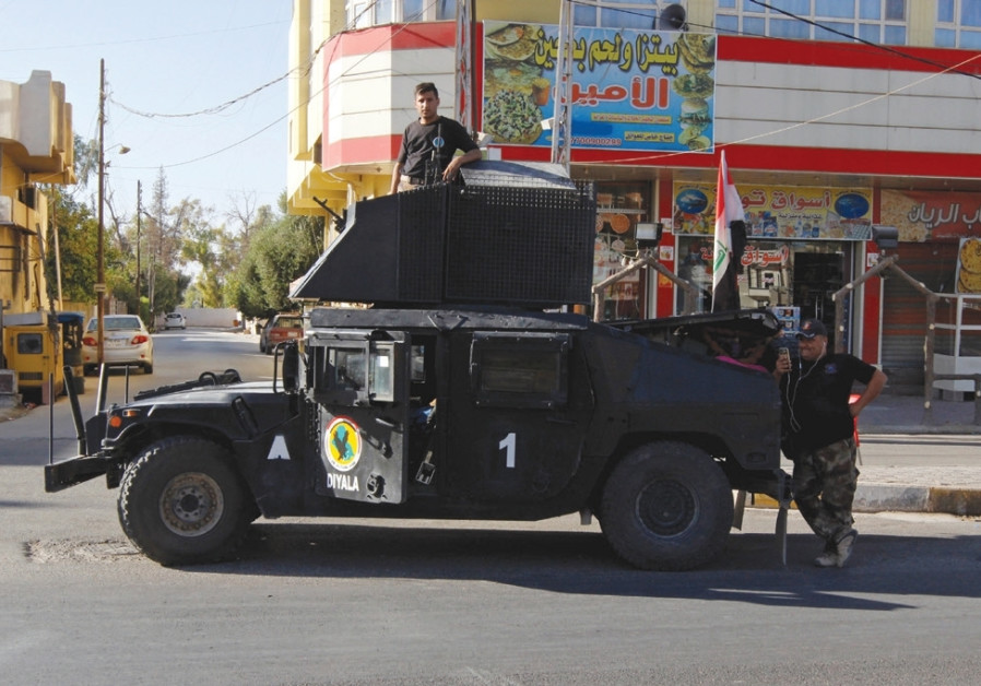 A VEHICLE of the Iraqi Federal Police is seen on a street in Kirkuk last month.