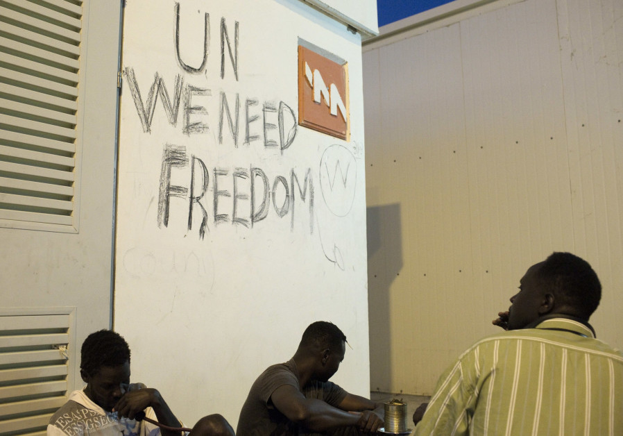 African migrants sit at the Holot open detention center in the Negev in Southern Israe