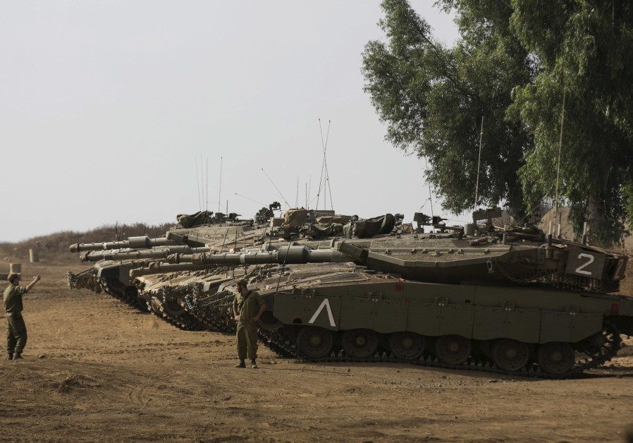 An Israeli soldier directs a tank during an exercise in the Golan Heights.