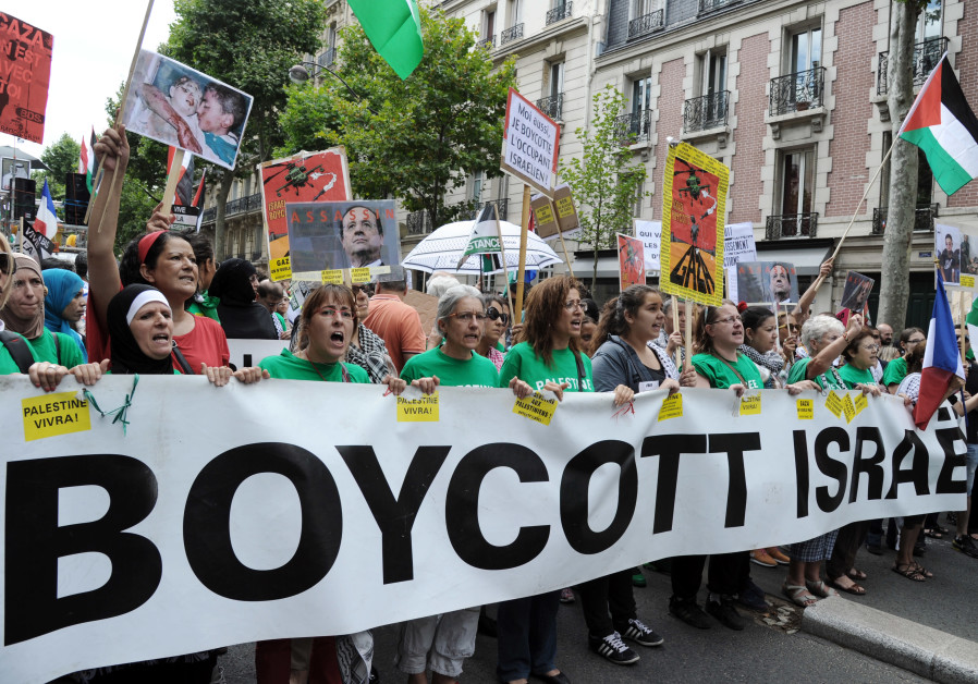 Protesters hold abanner that reads "Boycott Israel" during a pro-Palestinian demonstration in Paris