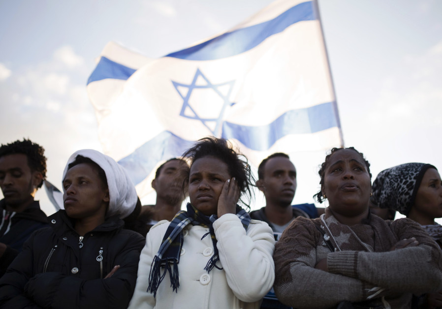 African migrants take part in a protest against Israel's detention policy toward them