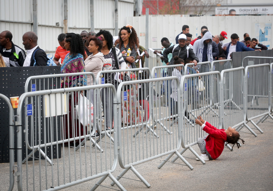 African asylum seekers wait to apply for a visa in Bnei Brak, Israel