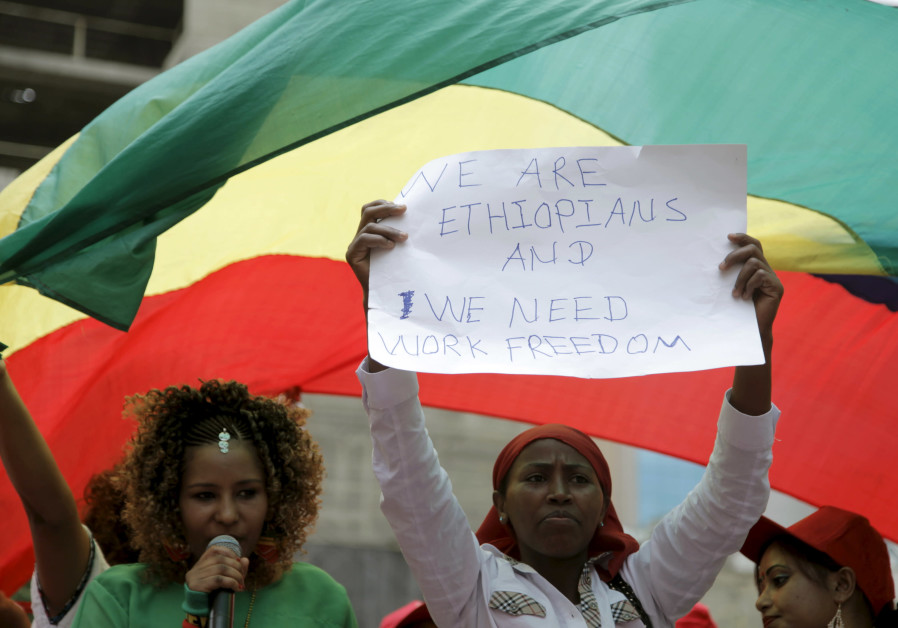 An Ethiopian migrant domestic worker holds up a placard during a parade in Beirut