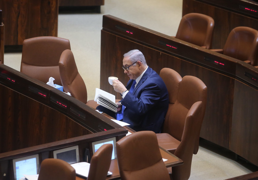 Prime Minister Benjamin Netanyahu reads in the Knesset, March 12, 2018.