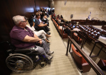Disabled activists sit in at the Knesset plenum discussing goverment allowances for the disabled