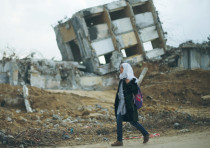 A GIRL WALKS by the remains of a house in the northern Gaza Strip that was destroyed.