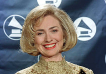 Hillary Rodham Clinton smiles as she holds her Grammy Award backstage, during the 39th Grammy Awards