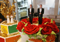 Bride and groom figurines are on display on wedding cakes at Cake and Art bakery in West Hollywood, 