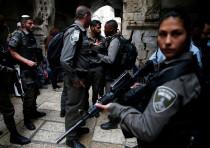 Israeli security forces stand at the site where an Israeli was killed in a stabbing attack