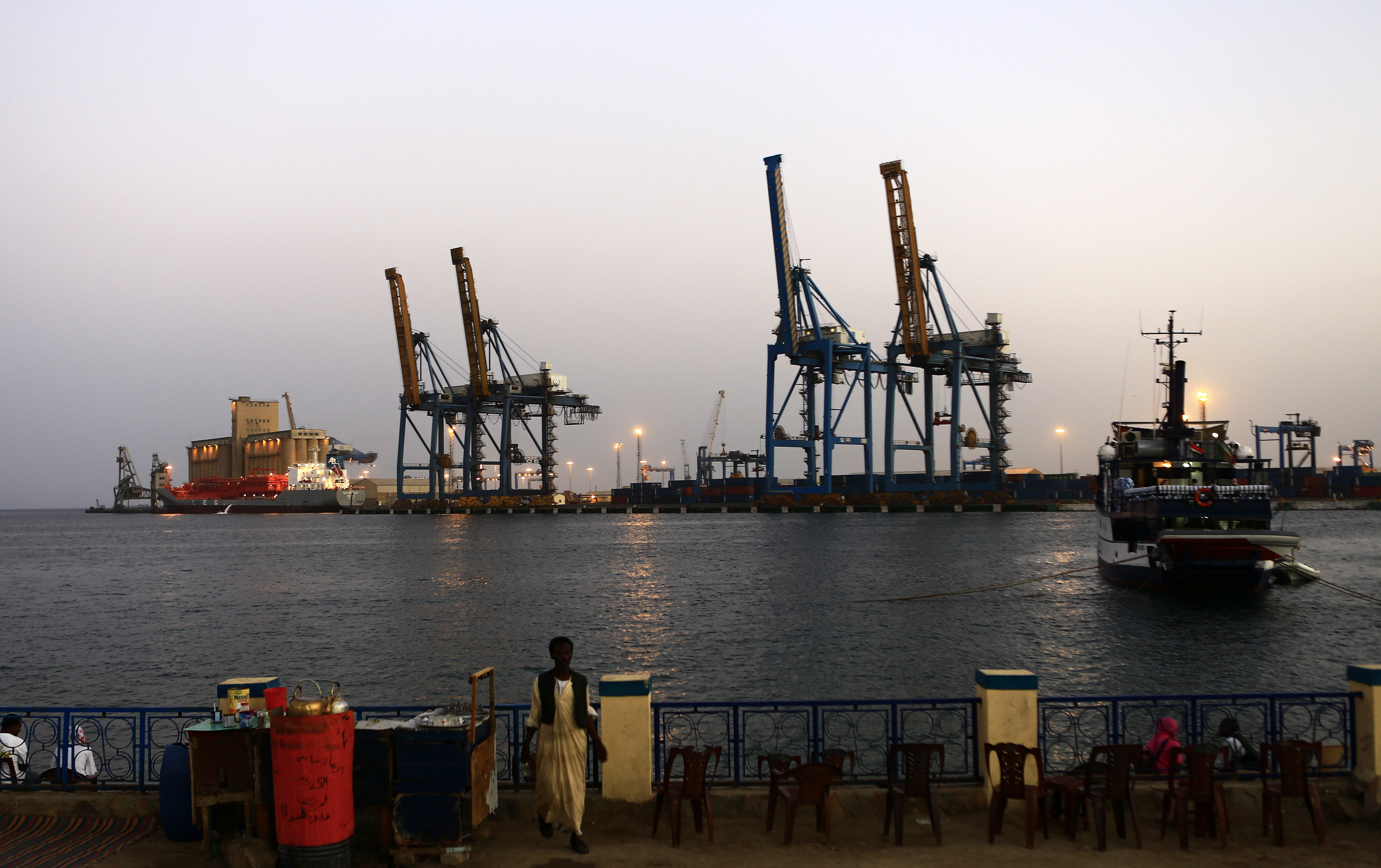 A man stands opposite the modern port at the harbour in Port Sudan, February 24, 2014. (Reuters)