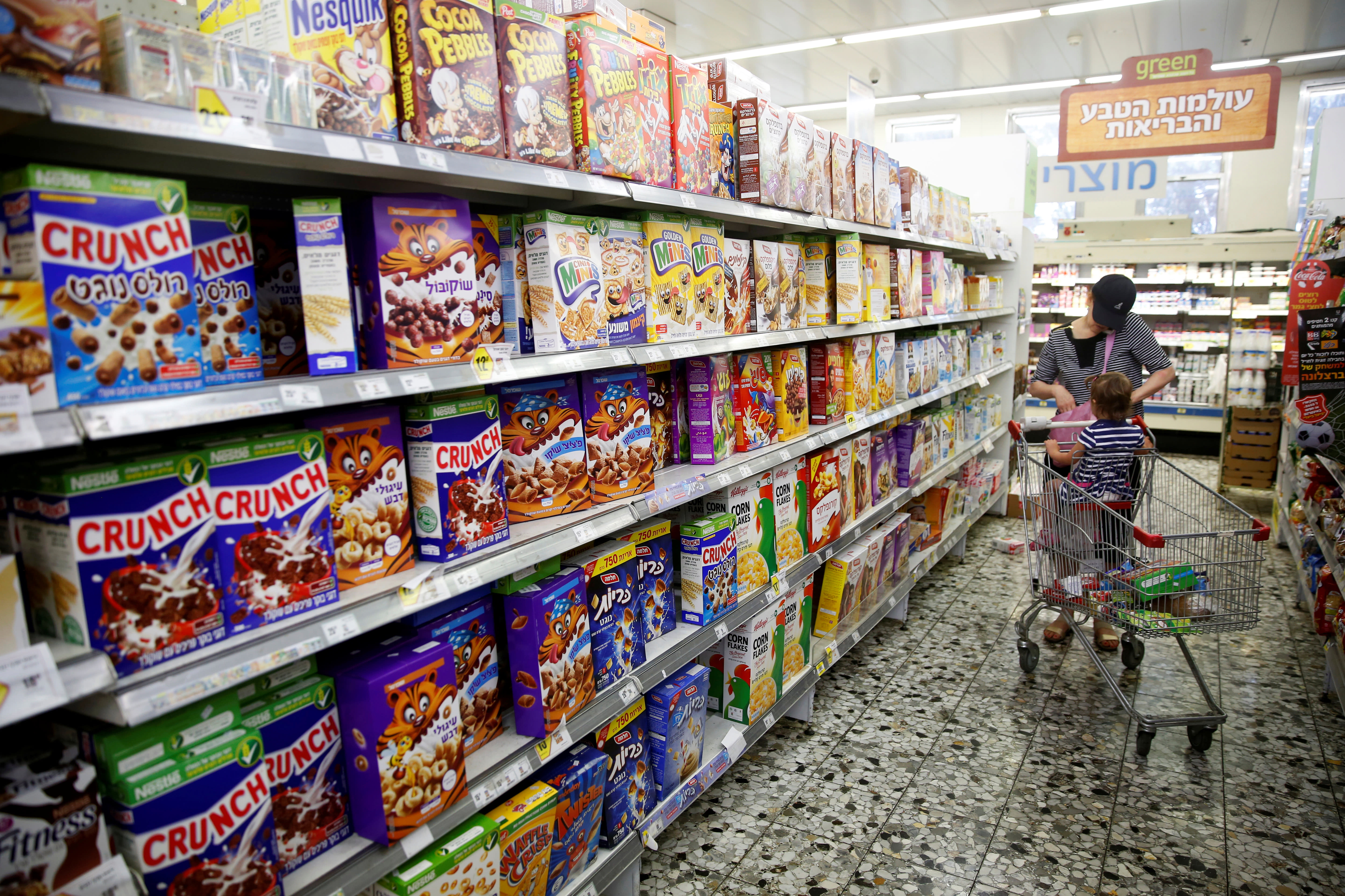 An Israeli woman shops at a Jerusalem supermarket (Reuters)