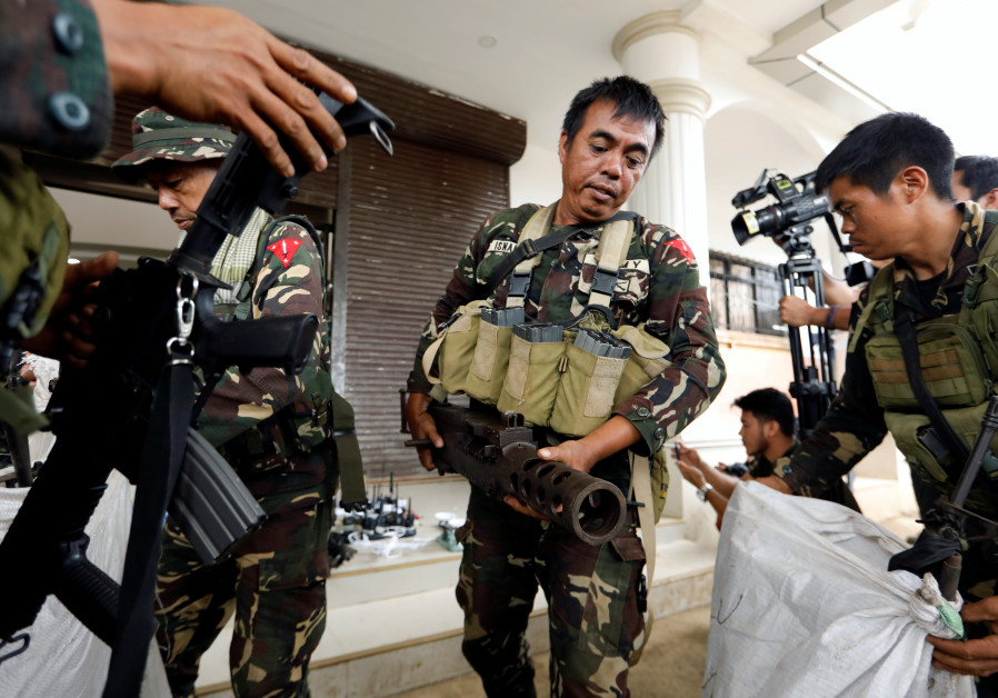Philippines army soldiers store seized combat weapons in bags.