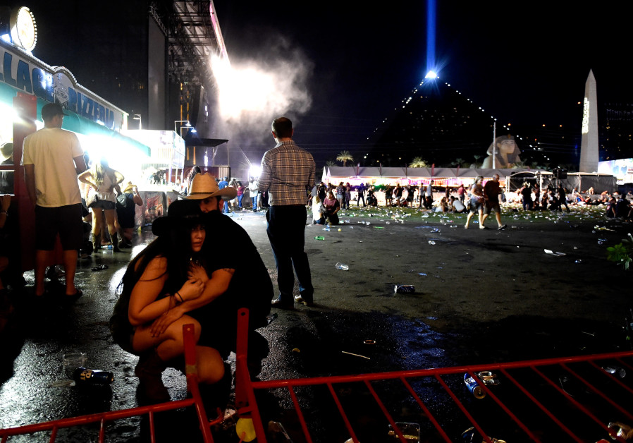  People take cover at the Route 91 Harvest country music festival in Las Vegas after gun fire