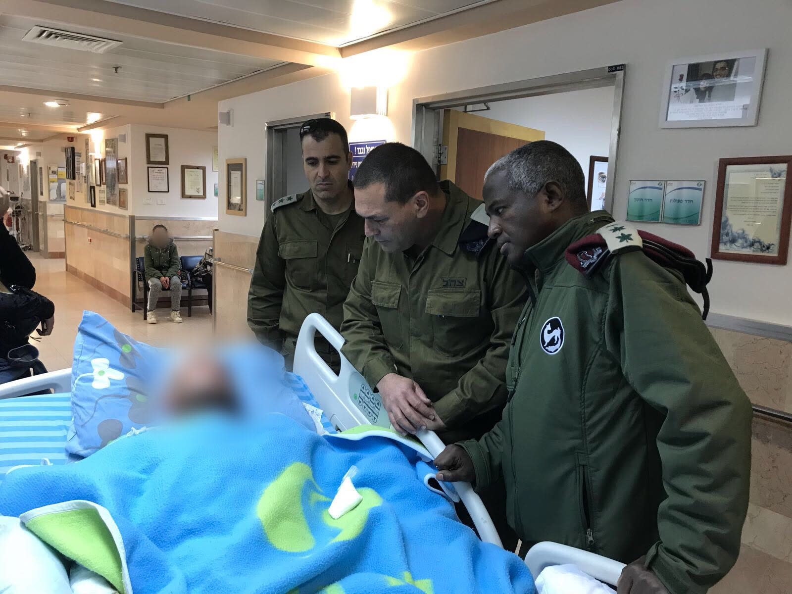 Southern Command Maj.-Gen. Eyal Zamir with one of the soldiers wounded on February 17, 2018 (IDF SPOKESPERSON'S UNIT)