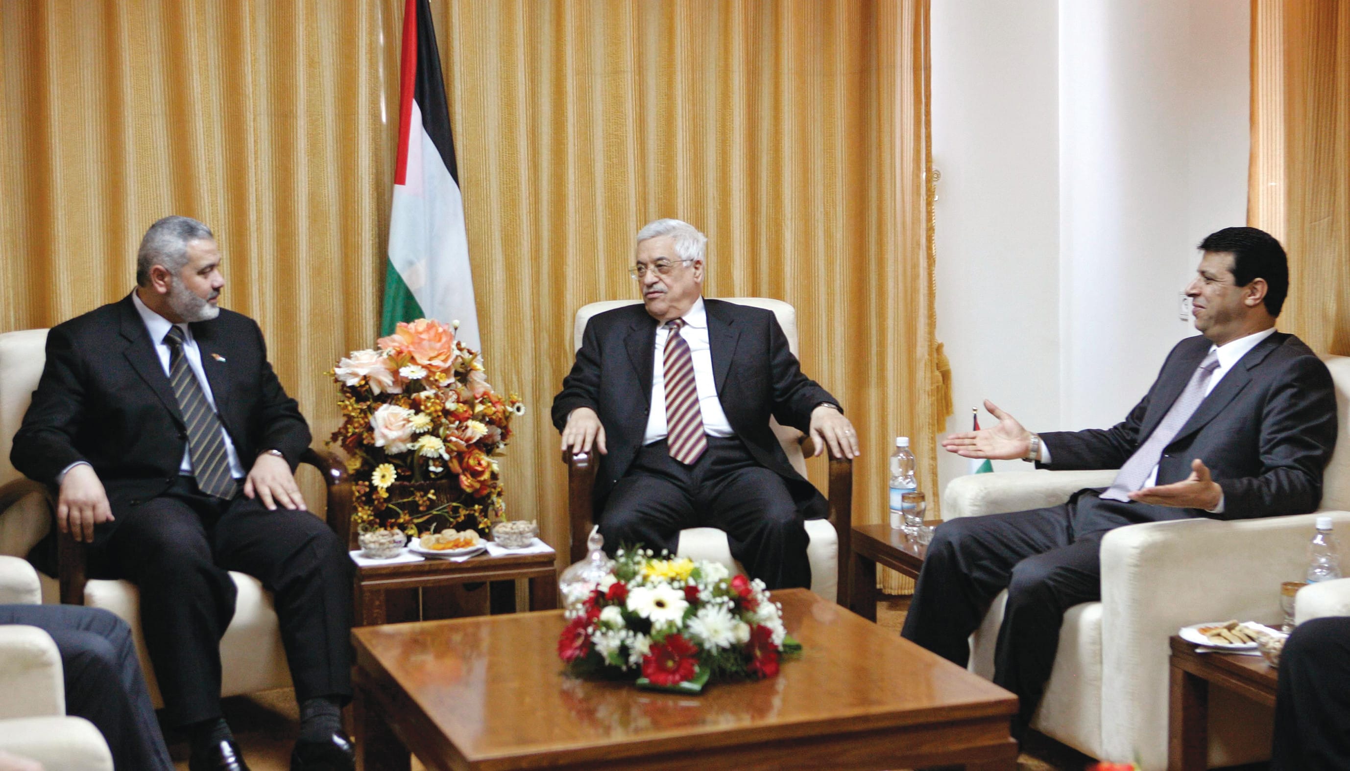 Palestinian Authority head Mahmoud Abbas is flanked by then-security adviser Mohammed Dahlan (right) and then-prime minister Ismail Haniyeh, at a meeting in Gaza, in April 2007.