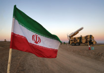 AN IRANIAN FLAG is pictured near in a missile during a military drill, with the participation of Ira