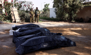  Israeli soldiers guard the bodies of victims of an attack following a mass infiltration by Hamas gunmen from the Gaza Strip, in Kibbutz Kfar Aza, in southern Israel, October 10, 2023.