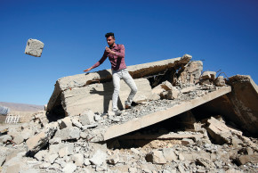 A YAZIDI man pulls rubble from his house in Sinjar that ISIS terrorists destroyed in February. 