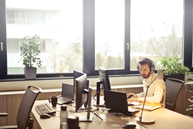 A man works in his office (illustrative) (photo credit: PEXELS)