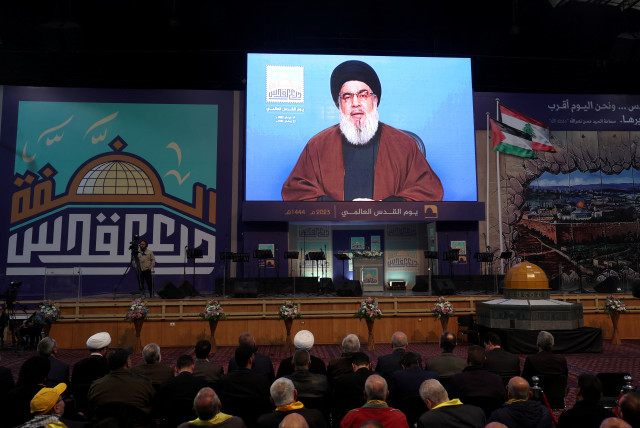 Lebanon's Hezbollah leader Sayyed Hassan Nasrallah addresses his supporters through a screen during a rally marking al-Quds Day, (Jerusalem Day) in Beirut's southern suburbs, Lebanon April 14, 2023 (photo credit: REUTERS/AZIZ TAHER)