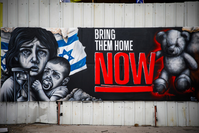A graffiti for the release of Israelis held hostage by Hamas terrorists in Gaza, in the northern Israeli city of Haifa, October 27, 2023 (photo credit: SHIR TOREM/FLASH90)