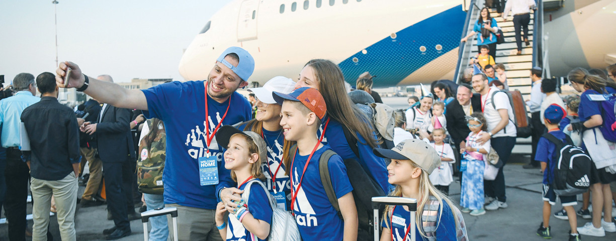  NEW IMMIGRANTS from North America arrive at Ben-Gurion Airport on a special El Al flight of the Nefesh B’Nefesh organization. Why do Jews from around the world, living comfortably in their birthplaces, leave everything they know and move to Israel?