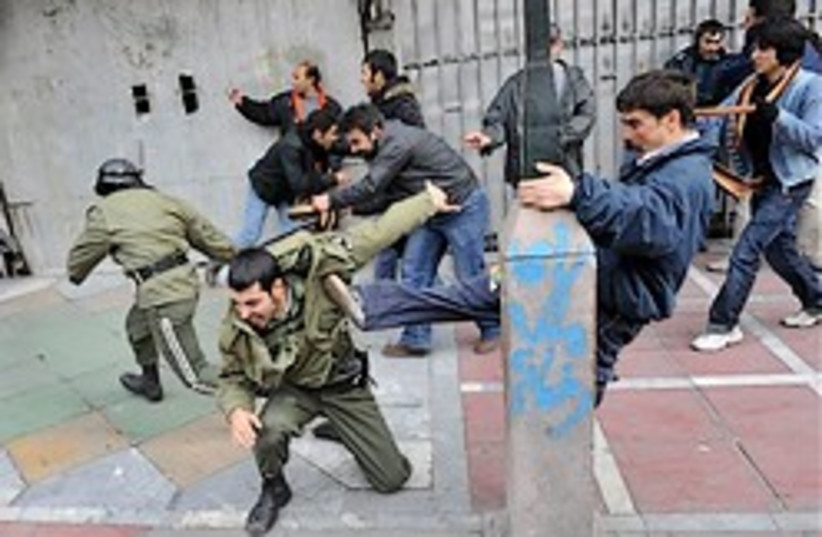 Iran protesters beat police 248.88 (photo credit: )