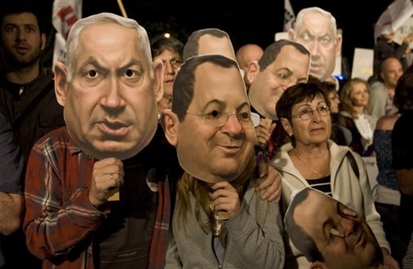 Israeli left-wing activists wearing masks (photo credit: AP)