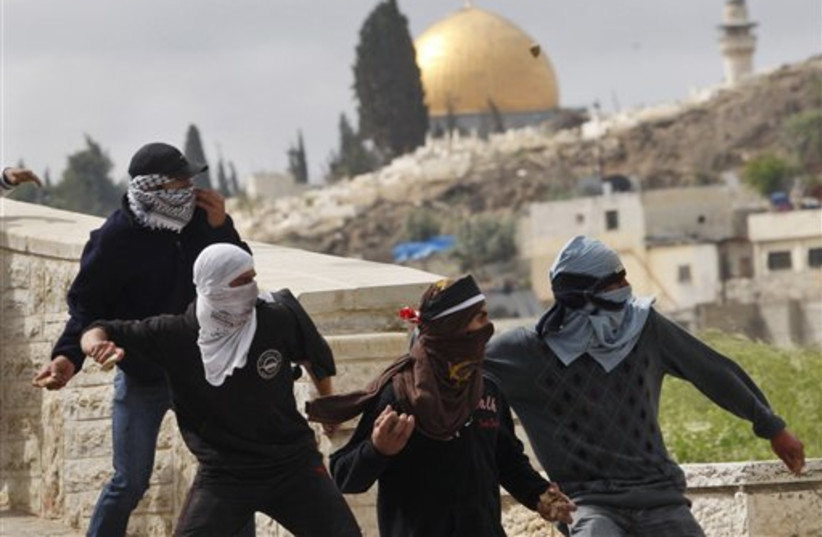 Palestinian demonstrators hurl stones (photo credit: AP)