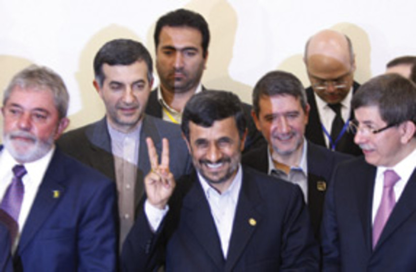 Ahmadinejad peace sign 311 (photo credit: Associated Press)