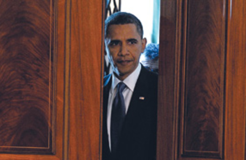 Obama peeking through doors 311 (photo credit: AP)
