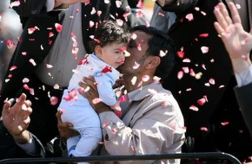 Ahmadinejad with baby (photo credit: Associated Press)