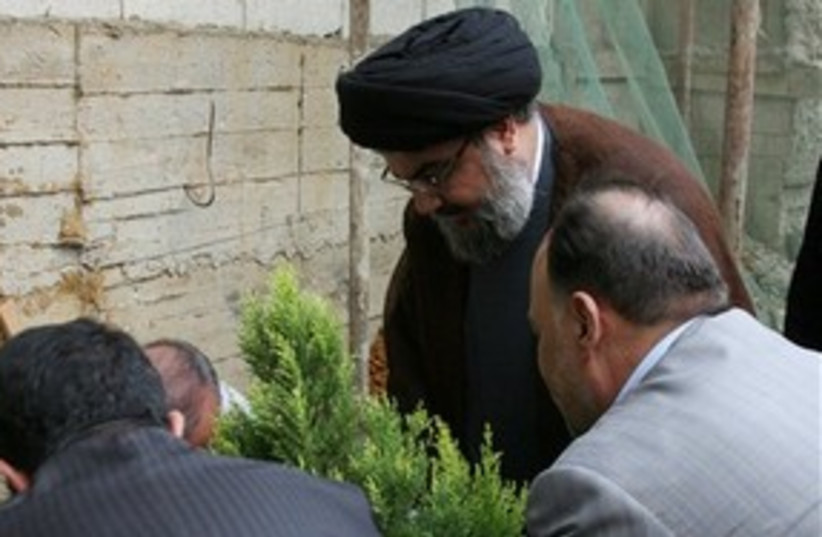 Nasrallah planting tree 311 AP (photo credit: AP)