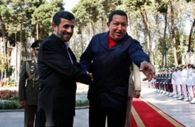 311_ahmadinejad, chavez goes for the grab (photo credit: Associated Press)
