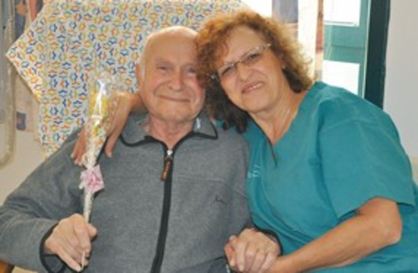 Nurse Josiann Shoshani hugs 80yr old  Avraham Rosenberg 311 (photo credit: Courtesy)