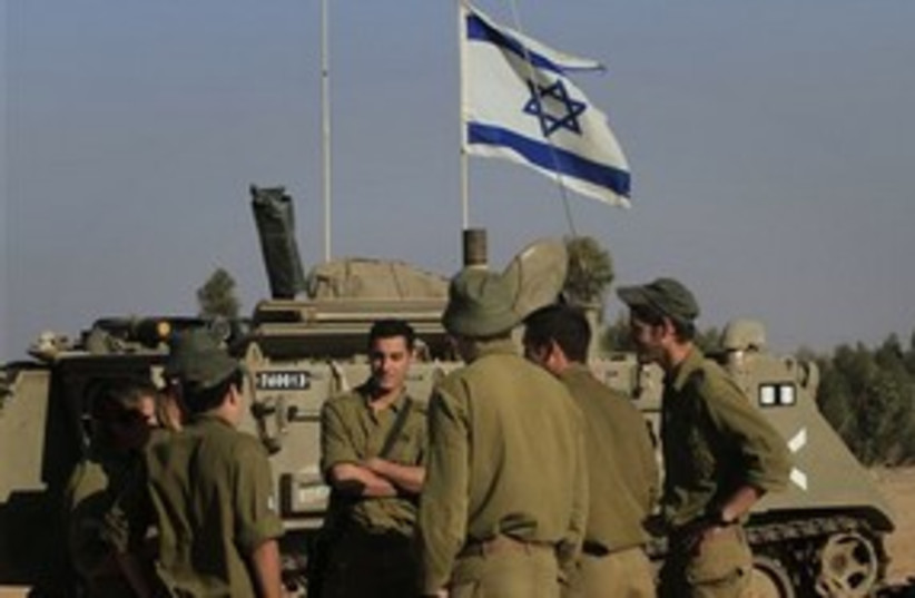 IDF troops with tank on Gaza border 311 AP (photo credit: AP)