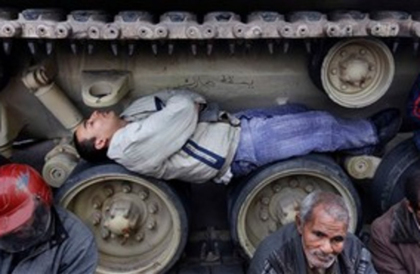 Egyptian man sleeps in tank tracks 311 AP (photo credit: AP)