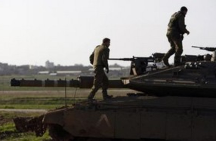 IDF soldiers on tank near Gaza border 311 (R) (photo credit: REUTERS/Amir Cohen)