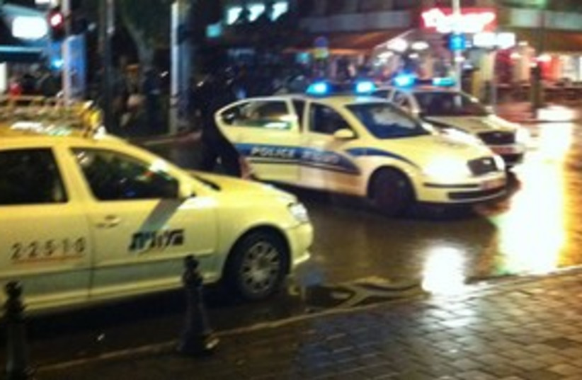 Police car and taxi in Tel Aviv at night 311 (photo credit: Yoni Cohen)