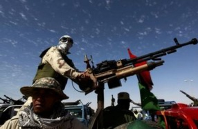 Libyan rebel with anti-aircraft gun 311 (R) (photo credit: REUTERS/Yannis Behrakis)