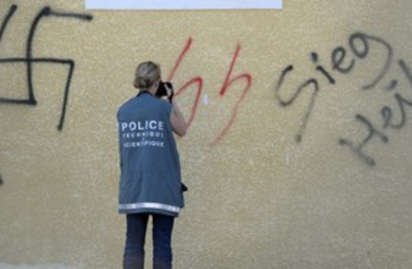 French police photograph neo-Nazi graffiti 311 (R) (photo credit: REUTERS)