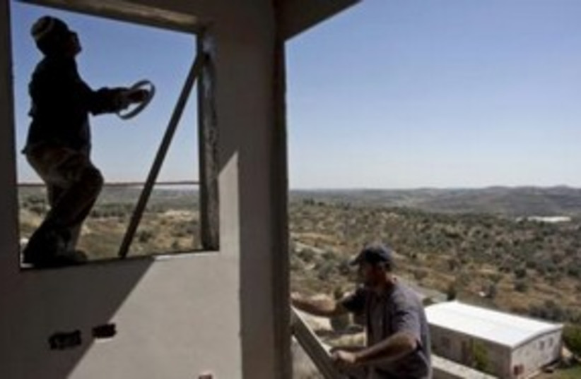 Palestinian workers build settlement home in Kedumim 311 (R) (photo credit: REUTERS/Nir Elias)