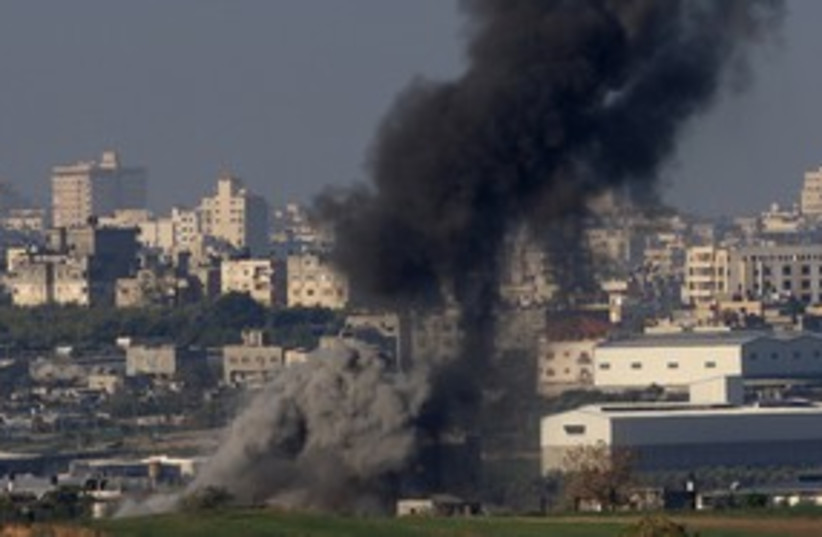 Smoke rises after an IAF airstrike in Gaza 311 (R) (photo credit: Ronen Zvulun/Reuters)
