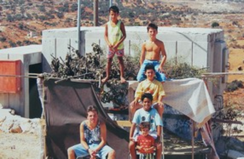 kids standing next to succa samaria 1990 (photo credit: Yosaif Cohain)