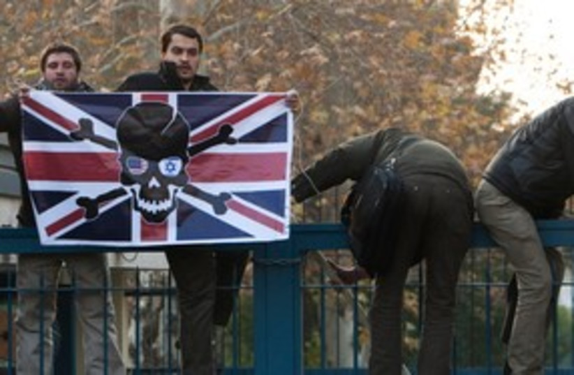Iranian demonstrators carry a British flag (R) 311 (photo credit:  REUTERS/Raheb Homavandi)