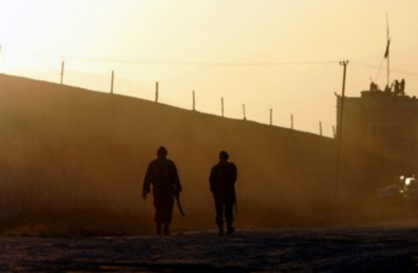 Afghan soldiers patrol outside a prison 390 (R) (photo credit: Ahmad Masood / Reuters)