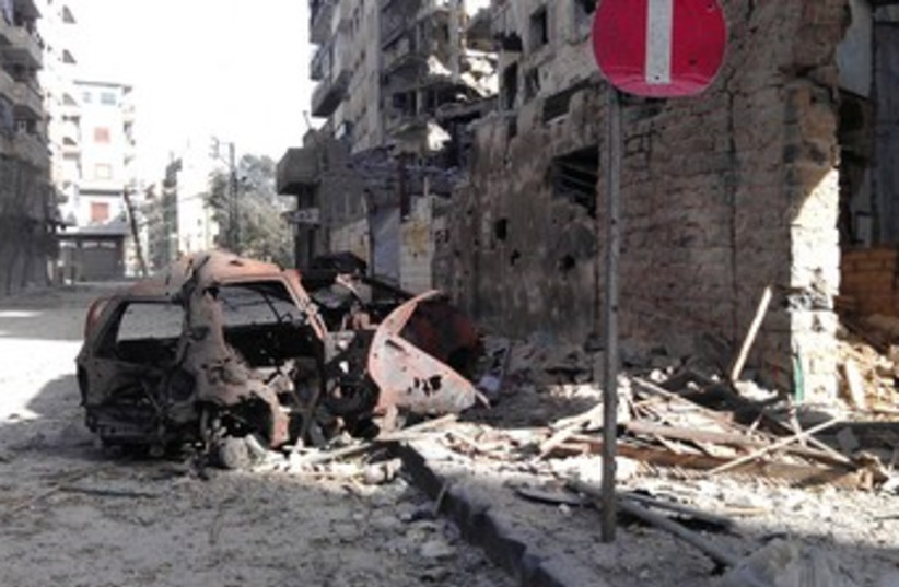 Buildings damaged by Syrian government shelling in Homs 370 (photo credit: REUTERS)