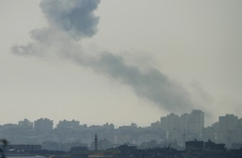 Smoke rises in Gaza after IAF air strike 370 (R) (photo credit: Amir Cohen/Reuters)